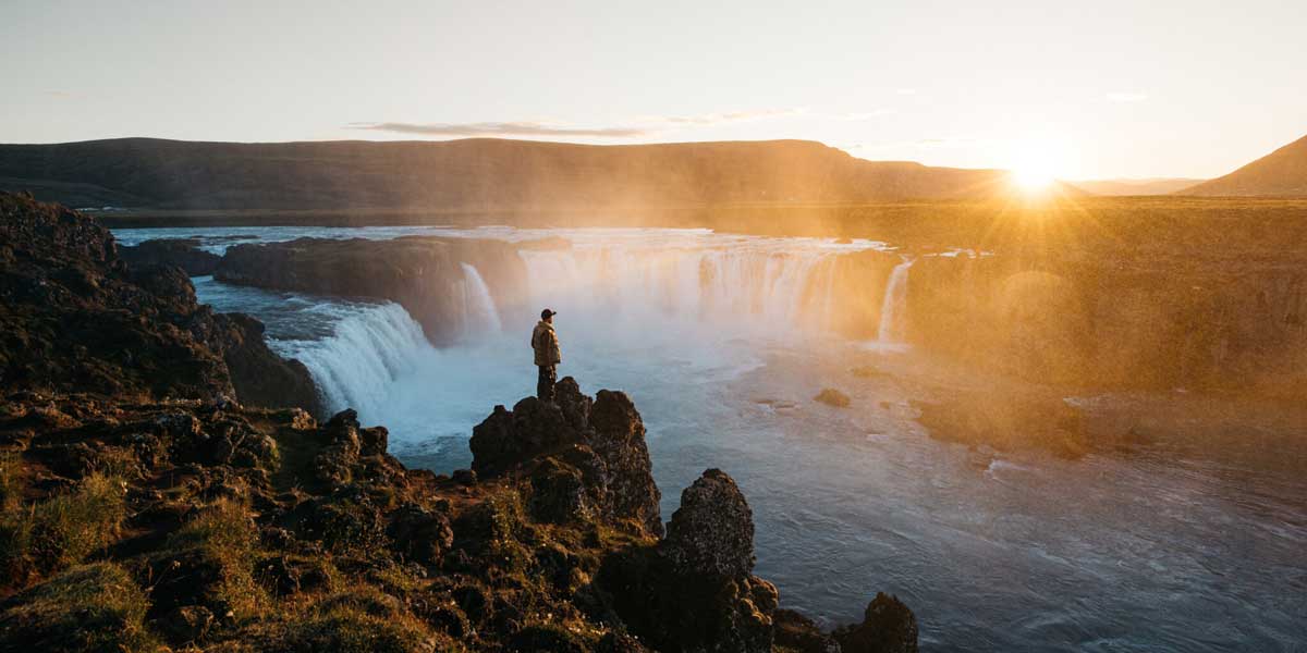 Johan Lolos on the edge of a mountain looking for that next perfect shot