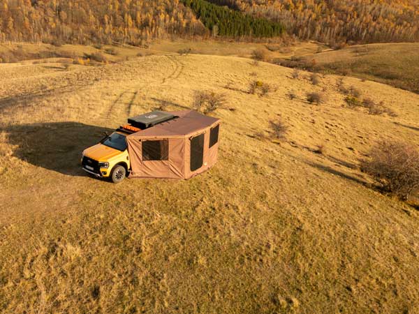 EDGE Overland awning with sidewalls installed at sunset during autumn