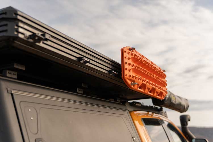 Left hand side view of Maxtraxx traction boards mounted on the traction board holder for rooftop tents.