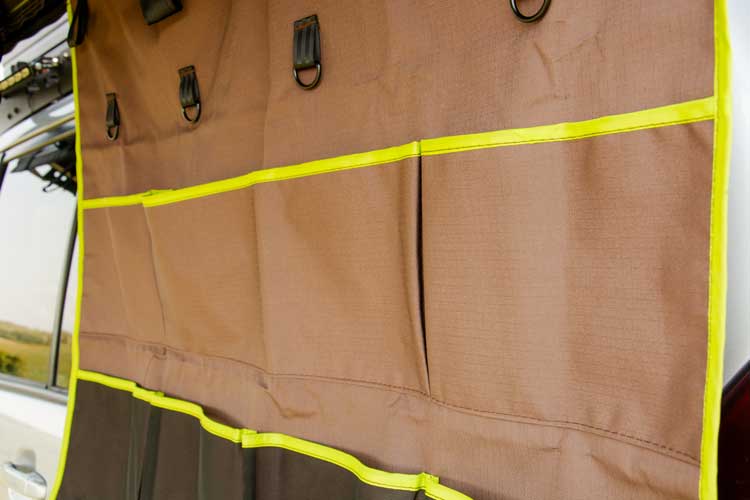 Second row with two smaller and one larger pocket for storing larger items in the Shelter Max organiser pockets.
