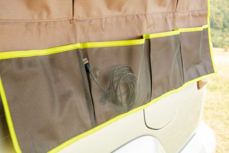 Bottom row with 4 transparent pockets used for storing smaller items that can easily get lost in the Shelter Max organiser pockets.