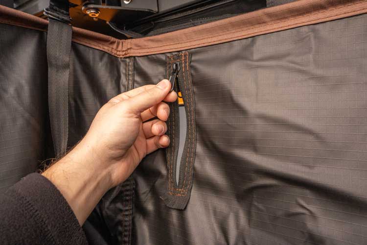 Access pocket for introducing the shower head into the shower awning.